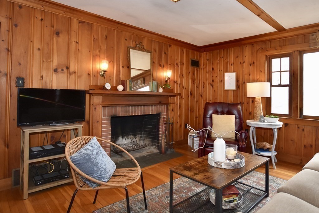 460 Williston Road Bourne, MA 02562 - Photo 9 of 37 a living room with furniture a flat screen tv and a fireplace