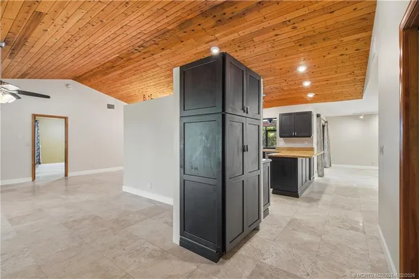 a kitchen with stainless steel appliances kitchen island granite countertop a refrigerator and a sink