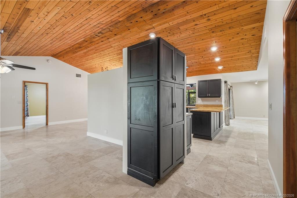 5186 Southeast Harrold Terrace Stuart, FL 34997 - Photo 14 of 50 a view of a refrigerator in kitchen and an empty room