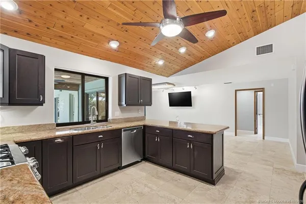 a kitchen with stainless steel appliances granite countertop a refrigerator and a sink