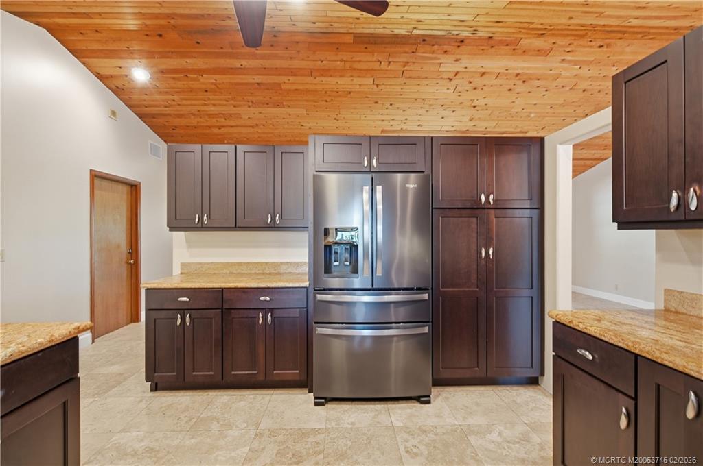 5186 Southeast Harrold Terrace Stuart, FL 34997 - Photo 18 of 50 a kitchen with stainless steel appliances granite countertop a refrigerator and a sink