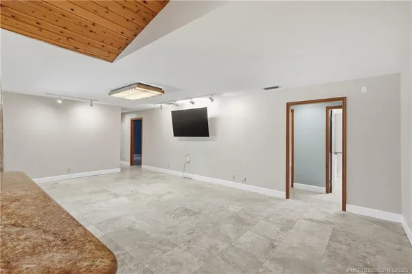 a large kitchen with a sink and cabinets