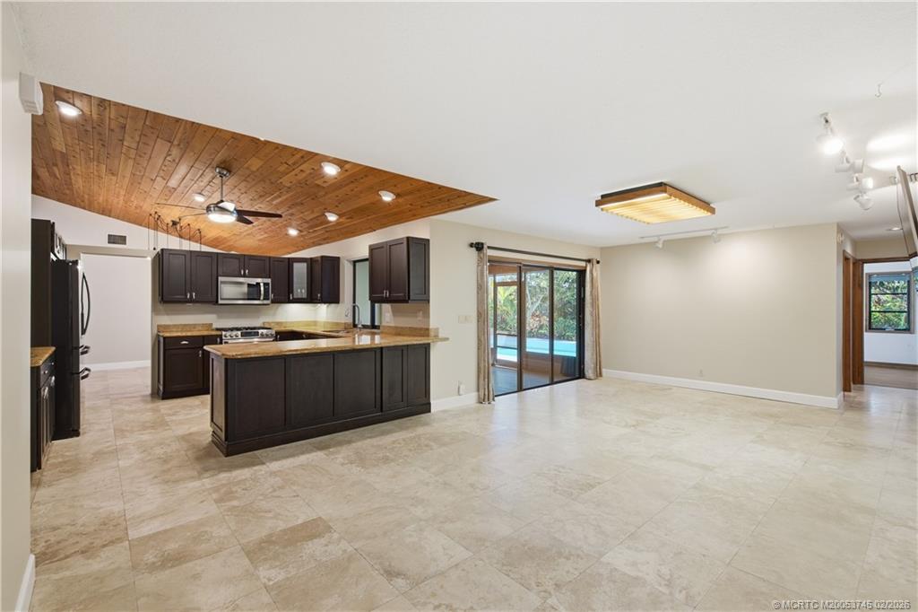 5186 Southeast Harrold Terrace Stuart, FL 34997 - Photo 20 of 50 a large kitchen with a sink and cabinets