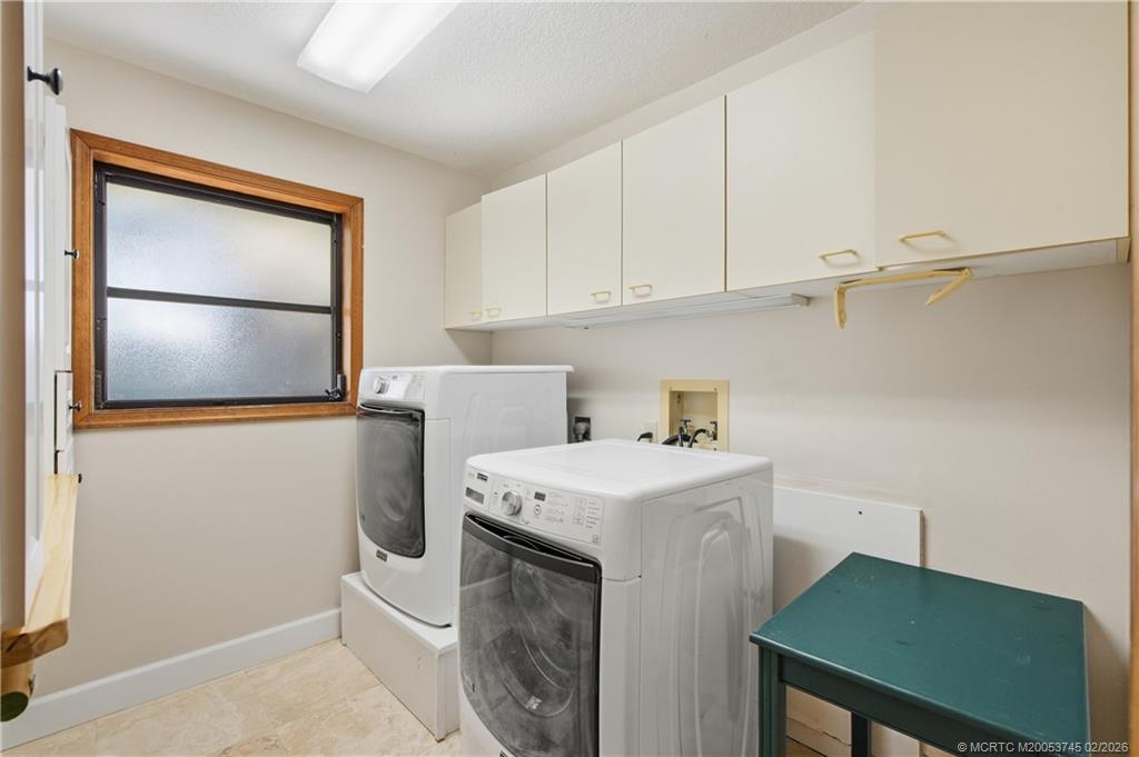 5186 Southeast Harrold Terrace Stuart, FL 34997 - Photo 26 of 50 a utility room with dryer and washer