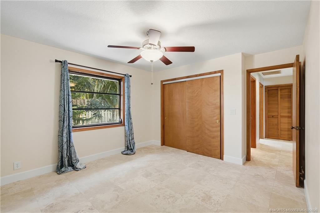 5186 Southeast Harrold Terrace Stuart, FL 34997 - Photo 28 of 50 a view of empty room with ceiling fan