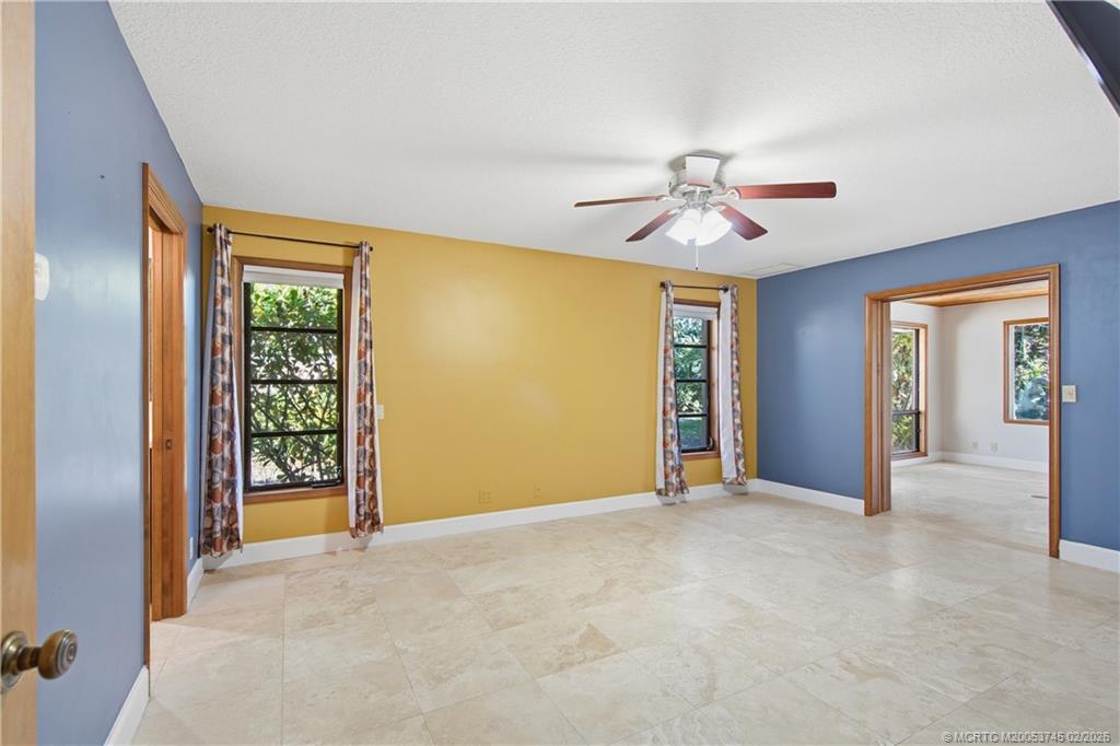 5186 Southeast Harrold Terrace Stuart, FL 34997 - Photo 29 of 50 a view of a livingroom with a chandelier fan and windows
