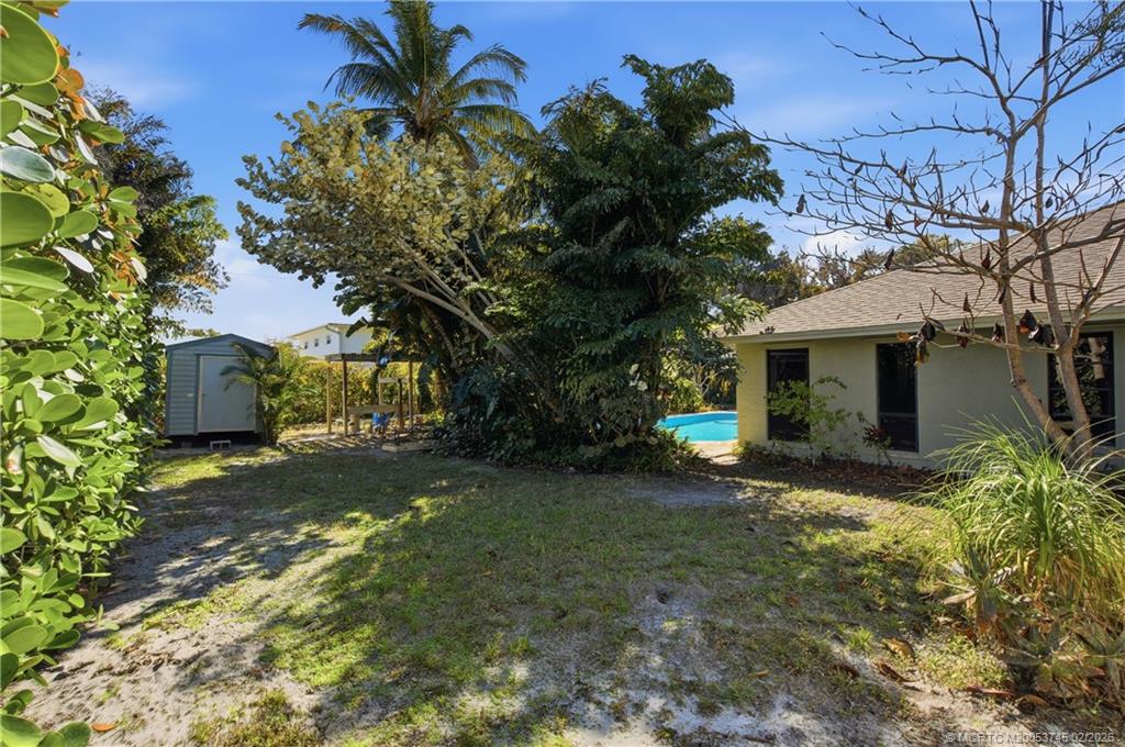 5186 Southeast Harrold Terrace Stuart, FL 34997 - Photo 41 of 50 a view of a house with a tree
