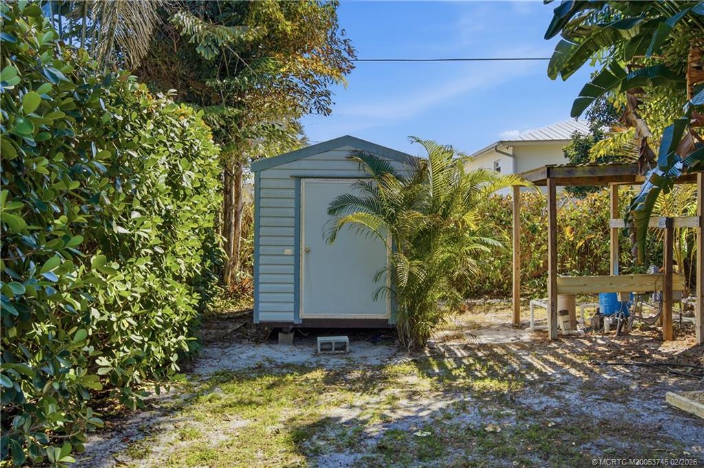 5186 Southeast Harrold Terrace Stuart, FL 34997 - Photo 42 of 50 a view of a house with a yard