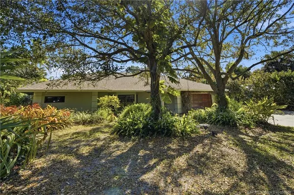an aerial view of a house with yard and outdoor seating