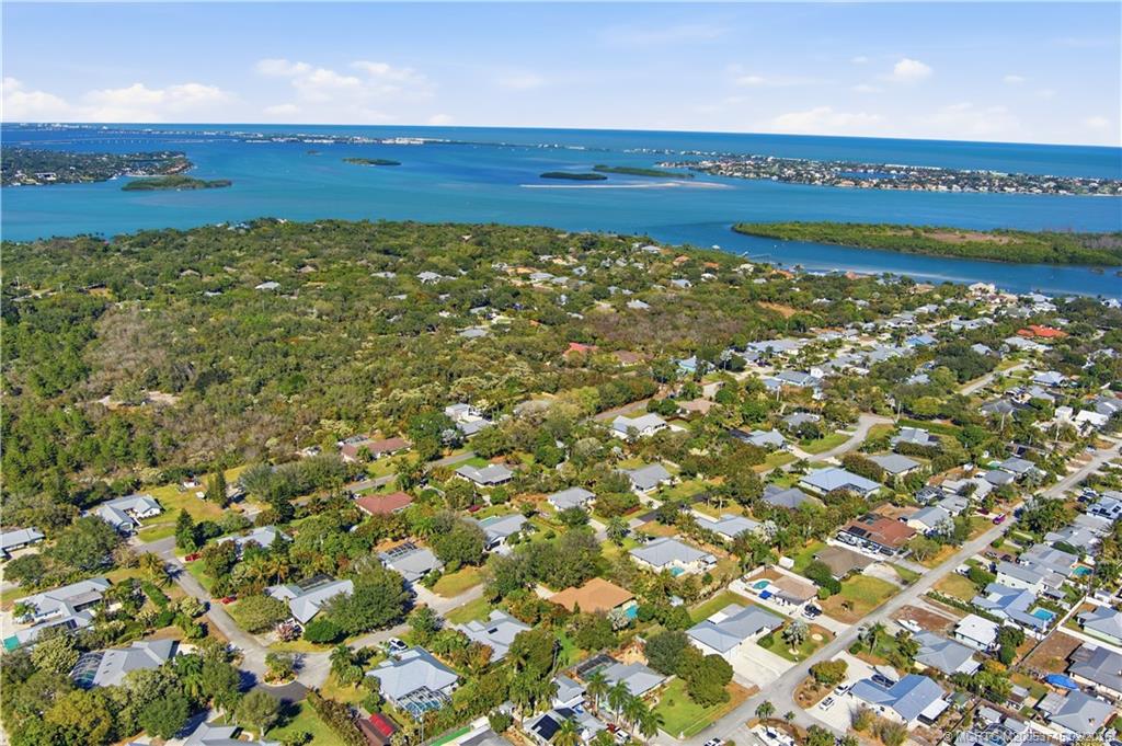 5186 Southeast Harrold Terrace Stuart, FL 34997 - Photo 47 of 50 a view of a large body of water with a building in the background