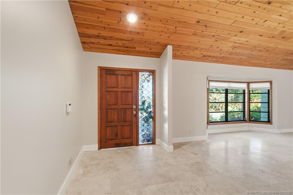5186 Southeast Harrold Terrace Stuart, FL 34997 - Photo 9 of 50 an empty room with windows