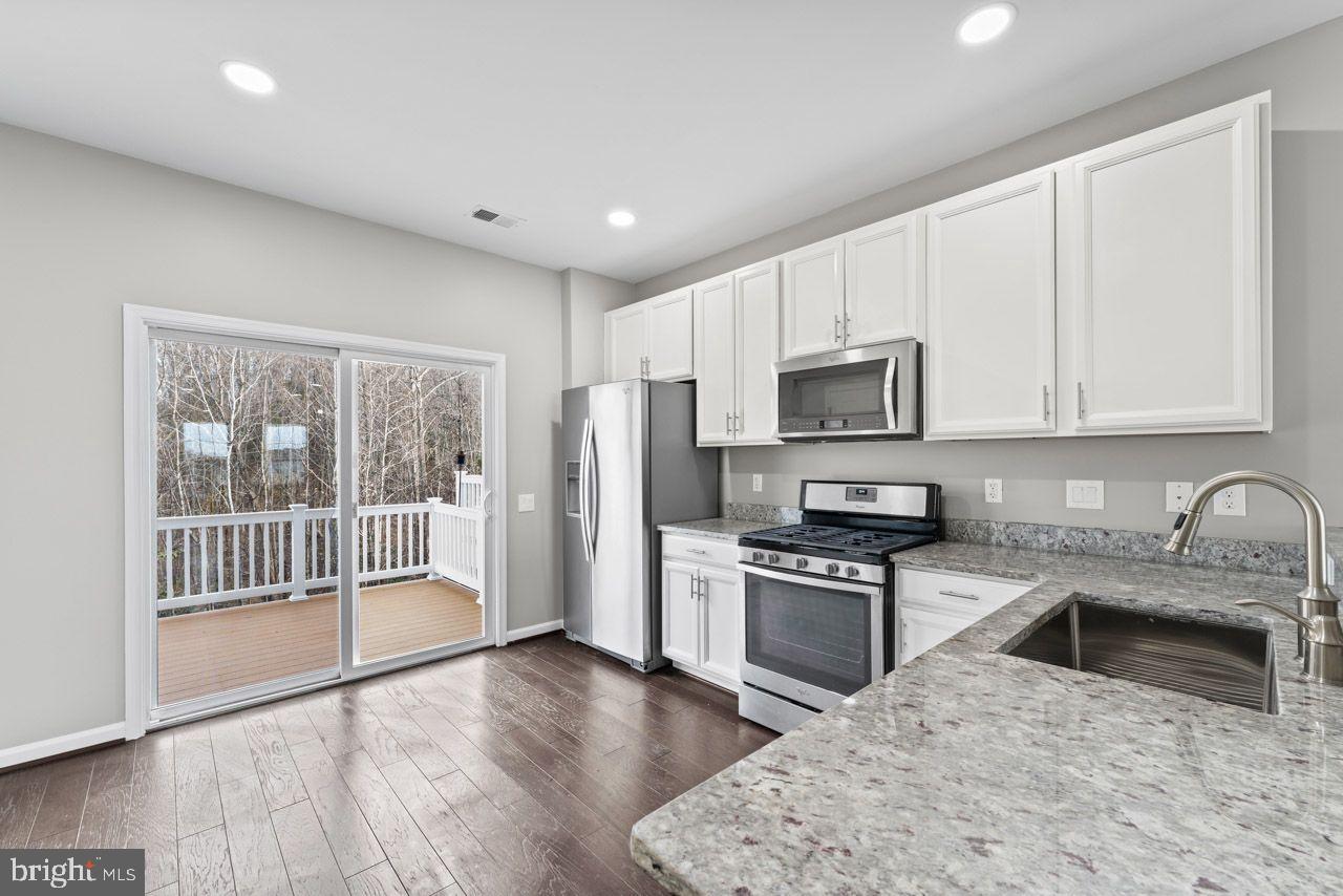 17045 Gibson Road Dumfries, VA 22026 - Photo 16 of 32 Modern kitchen with serene outdoor views.