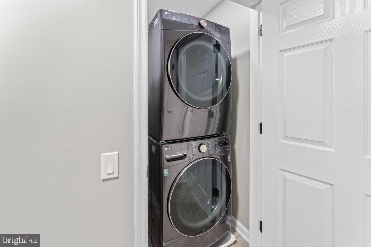 17045 Gibson Road Dumfries, VA 22026 - Photo 26 of 32 Sleek stacked laundry appliances in modern space.