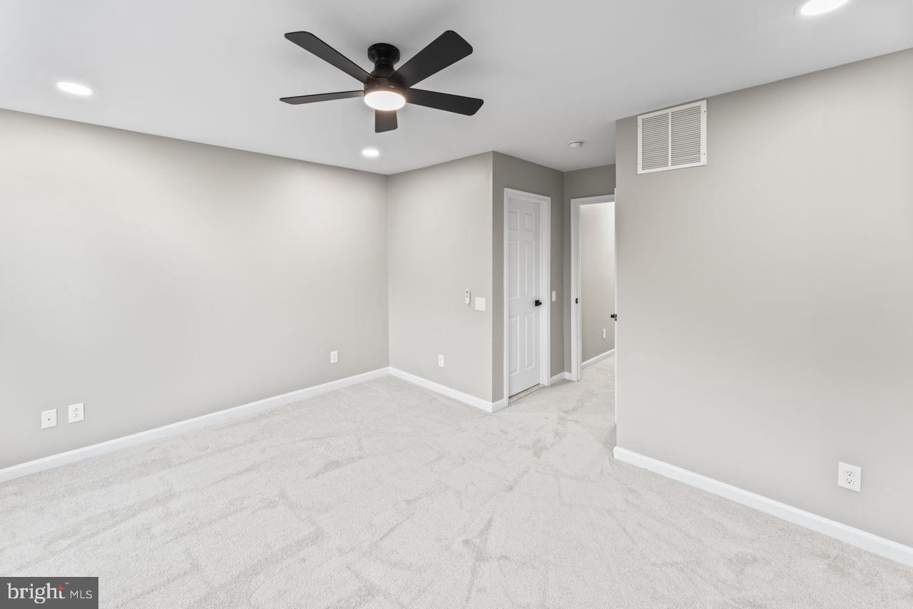 17045 Gibson Road Dumfries, VA 22026 - Photo 28 of 32 Spacious, modern room with sleek design.