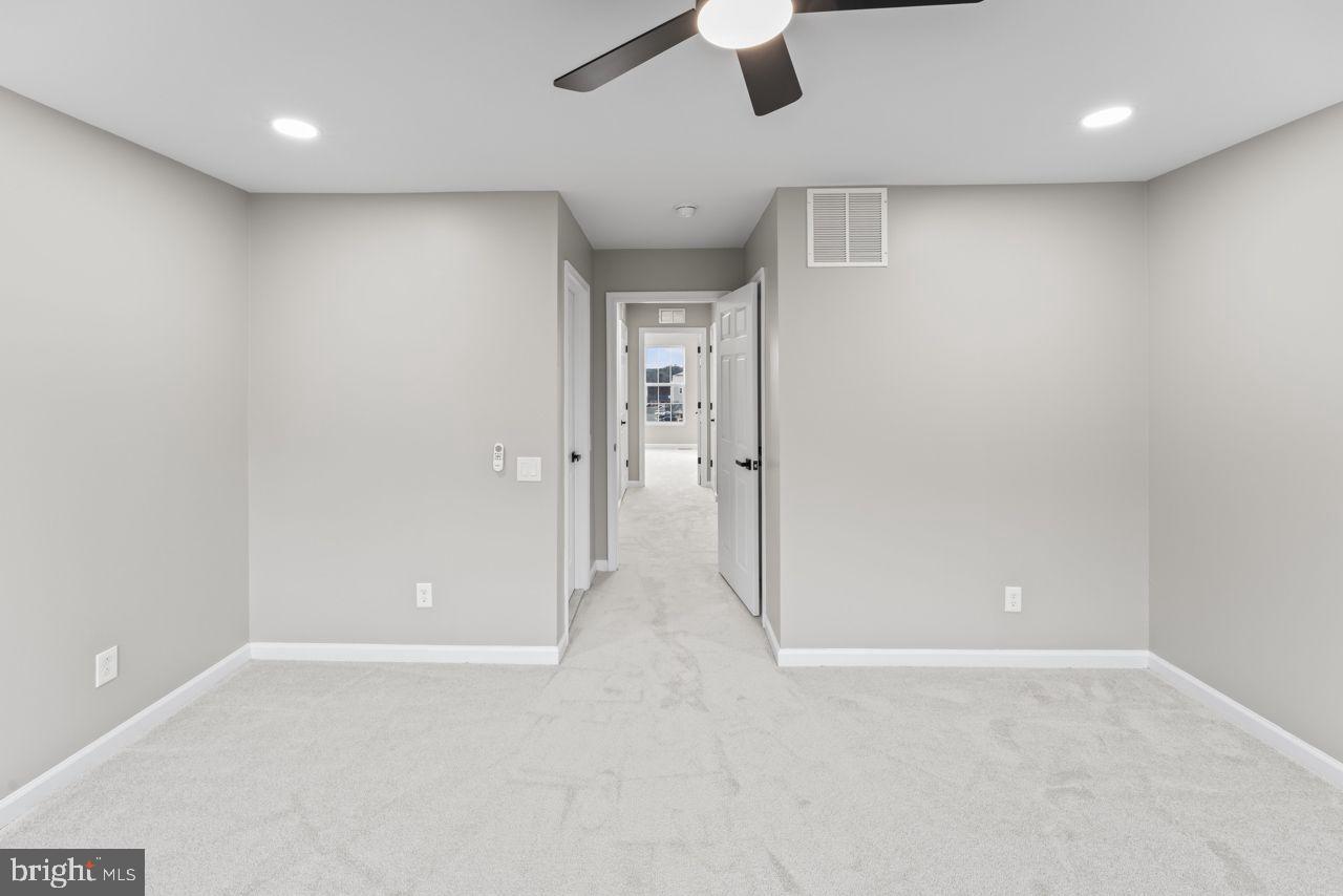 17045 Gibson Road Dumfries, VA 22026 - Photo 29 of 32 Spacious, modern hallway with soft lighting.