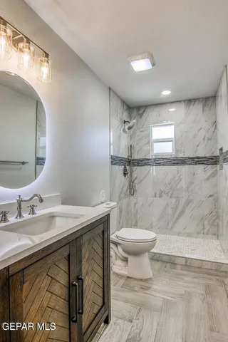 a bathroom with a sink toilet and a mirror