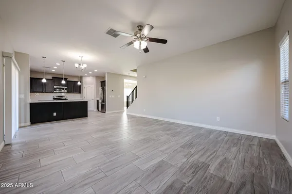 a view of a kitchen with a sink and a ceiling fan