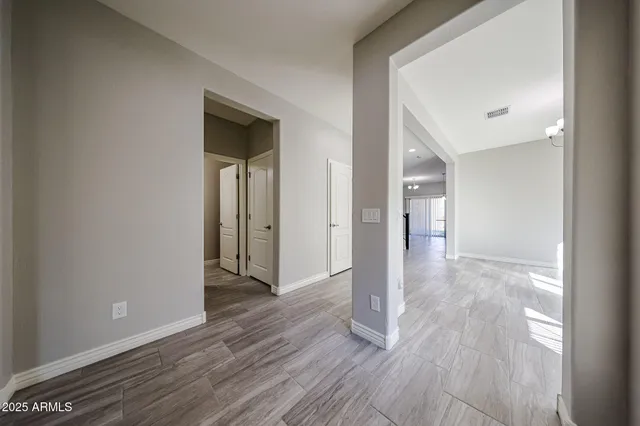 a view of hallway with wooden floor