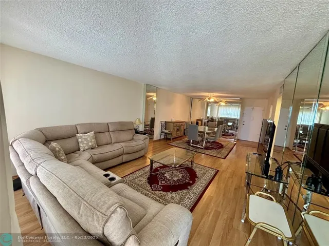 a living room with furniture fireplace and a flat screen tv