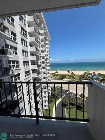 a view of a kitchen with a sink and refrigerator