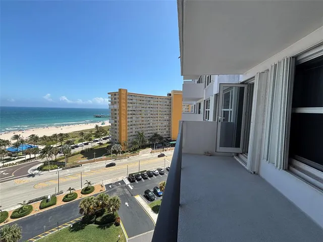 a view of a kitchen with kitchen island and stainless steel appliances