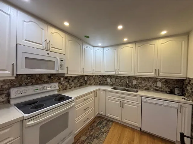 a bathroom with a sink a toilet a mirror and vanity