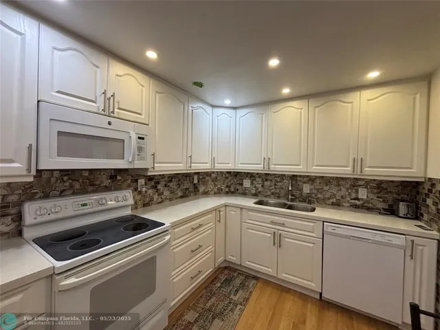 a spacious bedroom with a bed and a flat screen tv