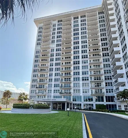 a view of a building with a yard