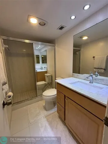 a spacious bathroom with a double vanity sink and a mirror