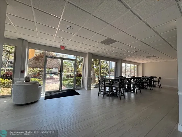 a dining room with furniture window and wooden floor