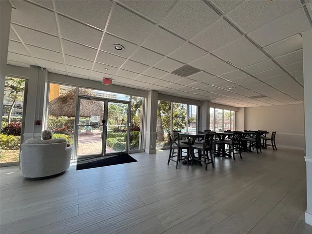 a dining room with wooden floor mountain view and a floor to ceiling window