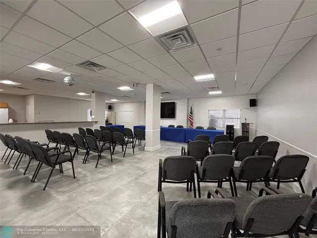 a group of people sitting in a room with furniture