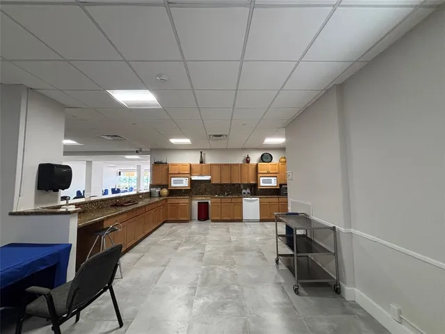 a kitchen with a table and chairs in it