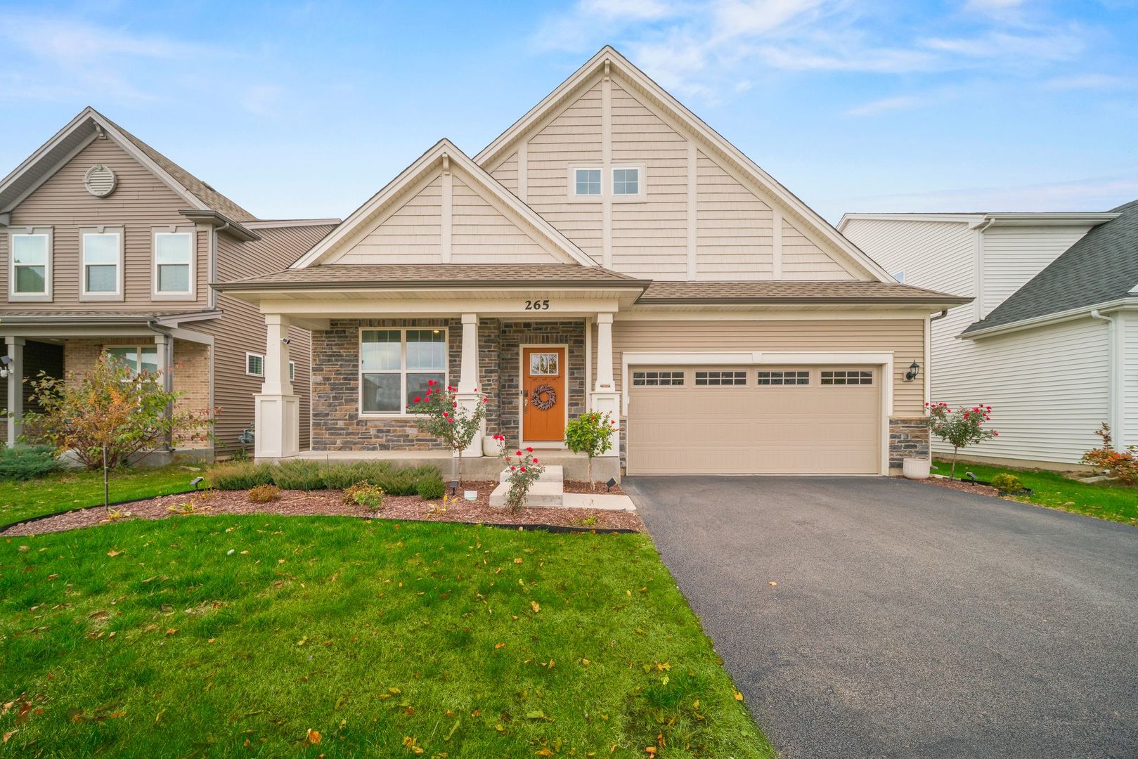 a front view of a house with a yard and porch
