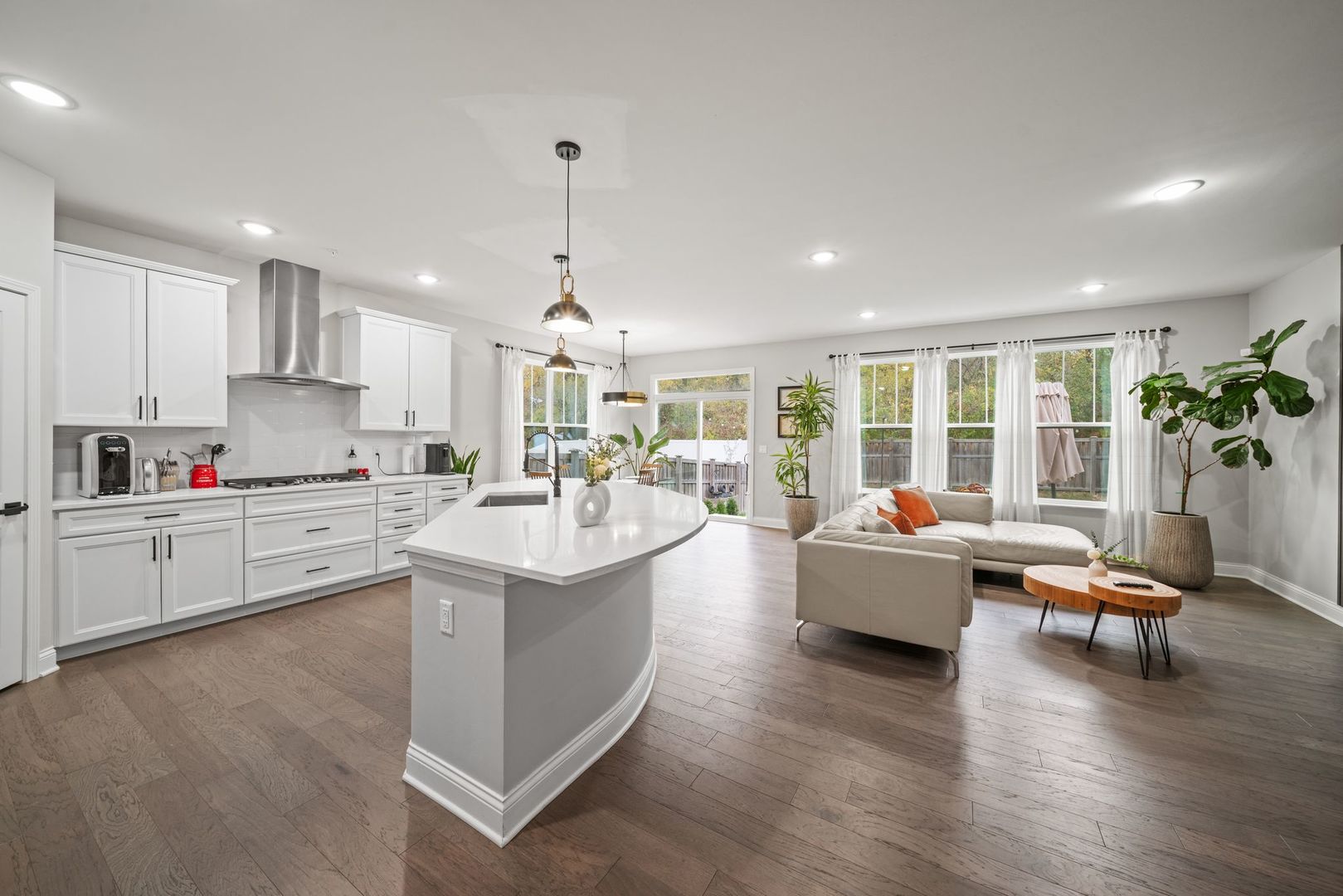265 South Pointe Avenue South Elgin, IL 60177 - Photo 12 of 43 a open kitchen with granite countertop a stove top oven a sink a dining table and chairs with wooden floor