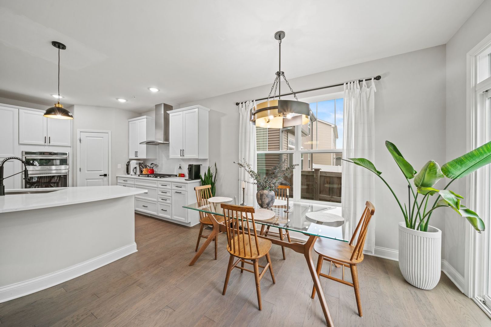 265 South Pointe Avenue South Elgin, IL 60177 - Photo 16 of 43 a kitchen with stainless steel appliances a table chairs and white wooden cabinets