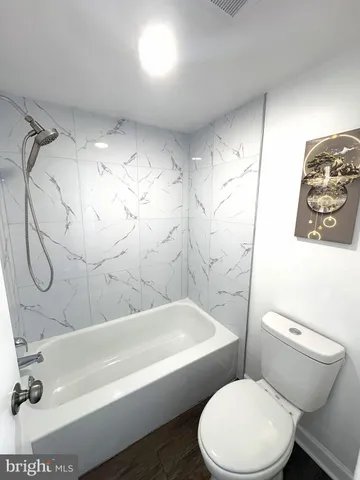 a bathroom with a toilet and shower