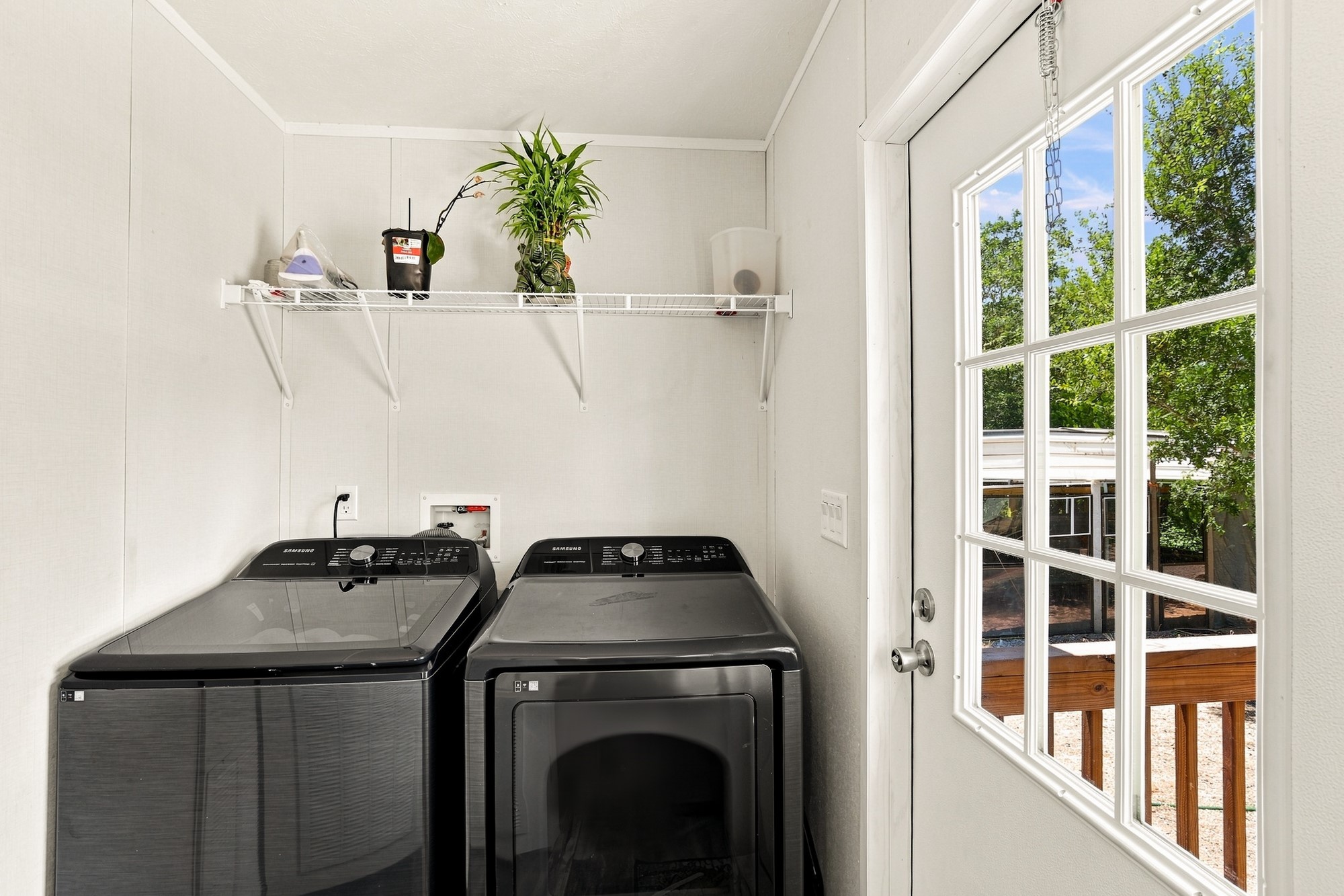 1039 Trailside Elgin, TX 78621 - Photo 17 of 24 Functional workspace includes laundry connections and a glass-paned door opening to the outdoors.
