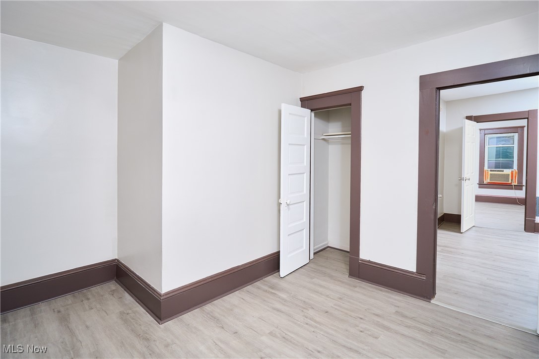 5432 State Road Parma, OH 44134 - Photo 39 of 47 Unfurnished bedroom with light wood finished floors, a closet, and cooling unit