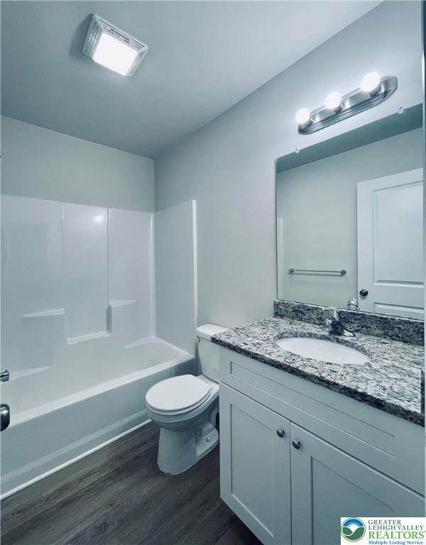 320 Barber Street, Unit LOT 32 Allentown, PA 18103 - Photo 35 of 53 a bathroom with a granite countertop toilet a sink and a mirror