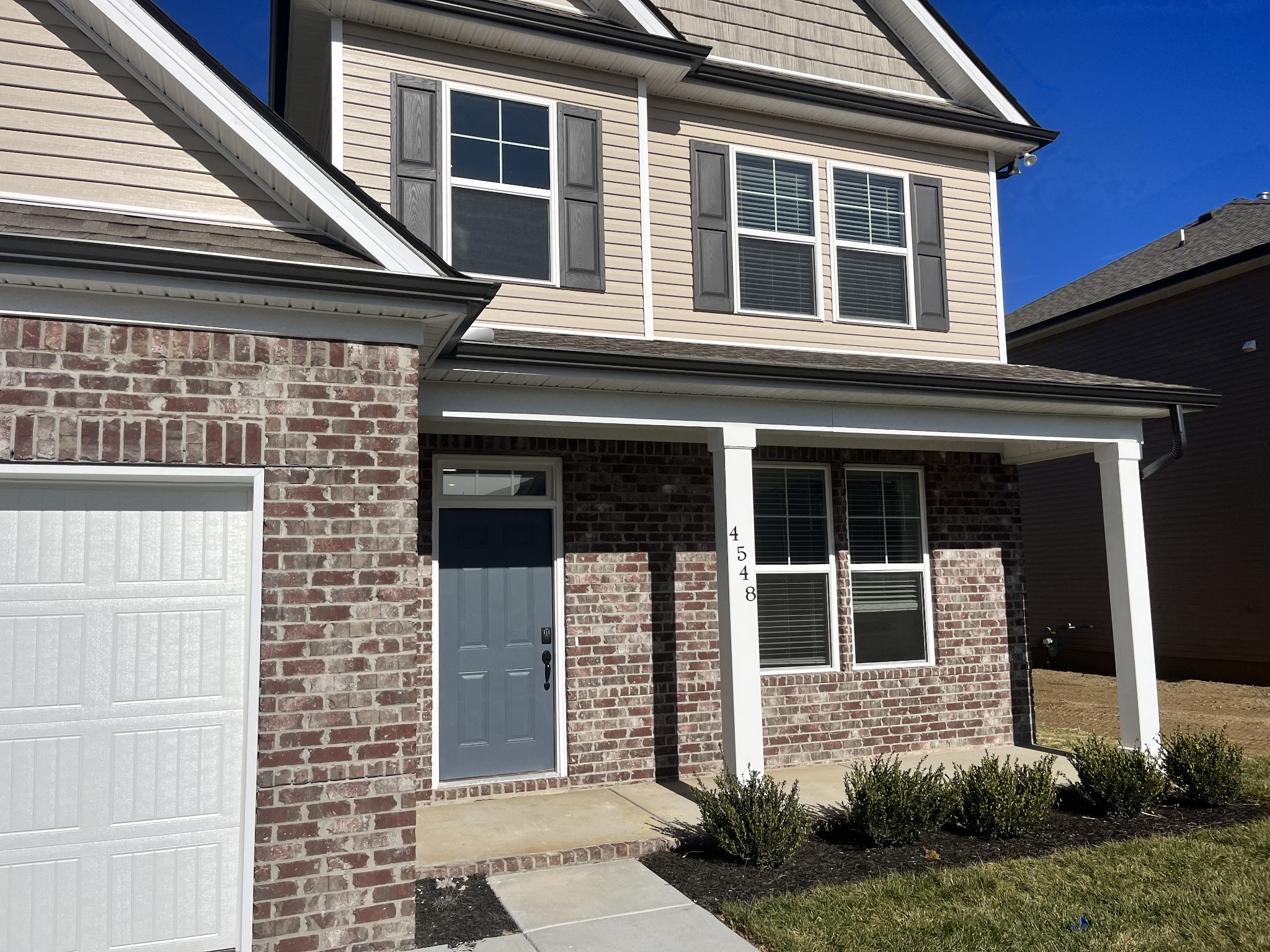 a front view of a house with a yard