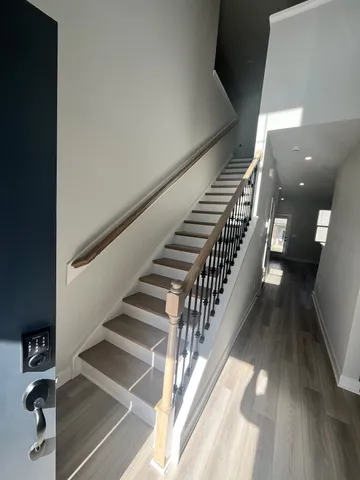 a view of entryway and hall with wooden floor