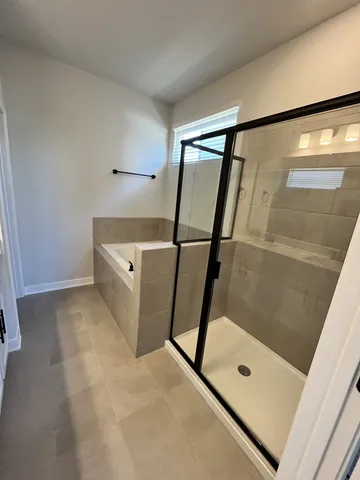 a bathroom with a shower and mirror