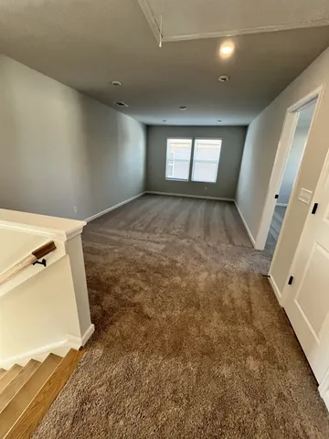 a view of a room with a fireplace and a window