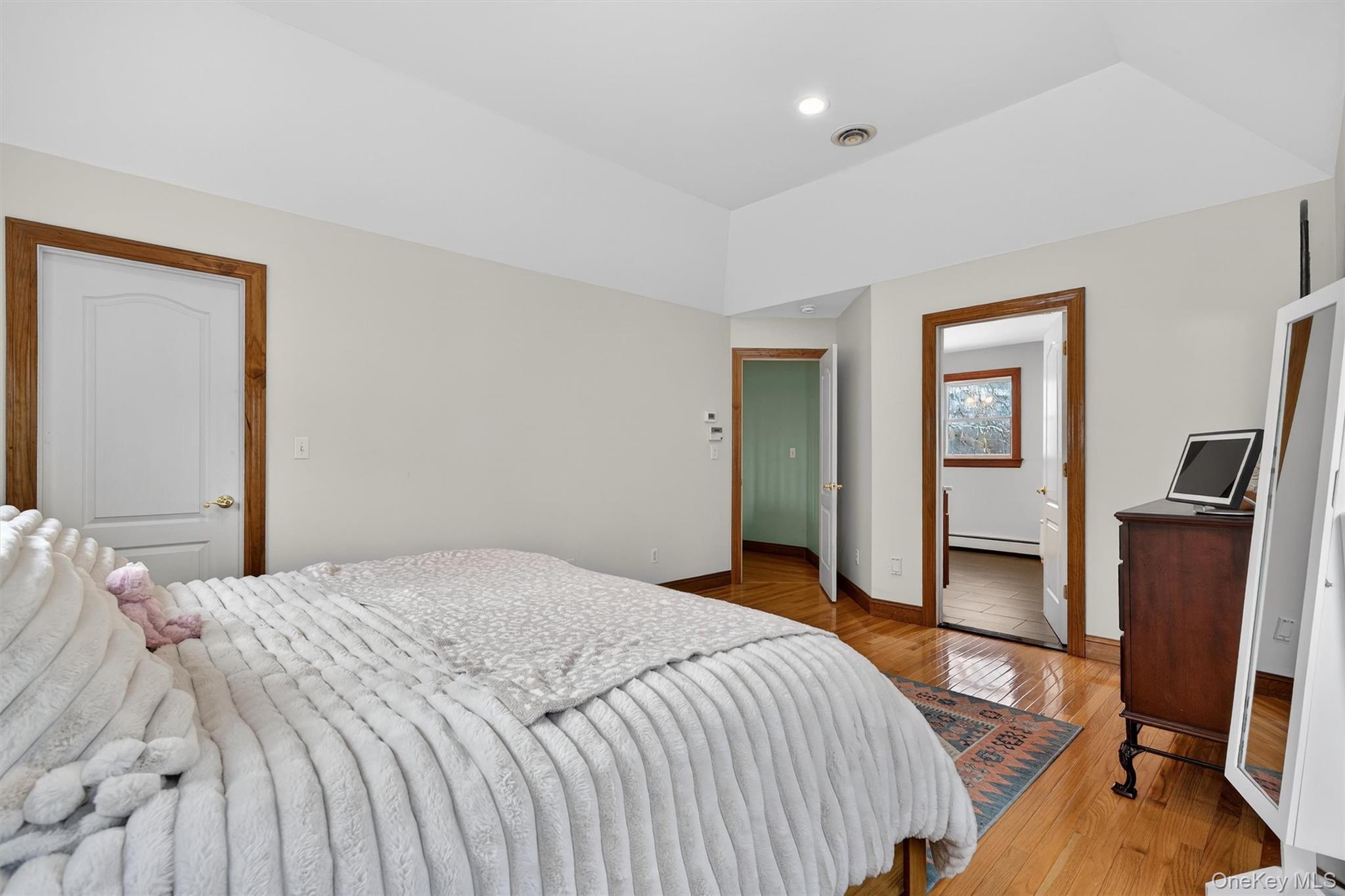 72 Coppergate Lane Warwick, NY 10990 - Photo 23 of 50 a bedroom with a bed and wooden floor