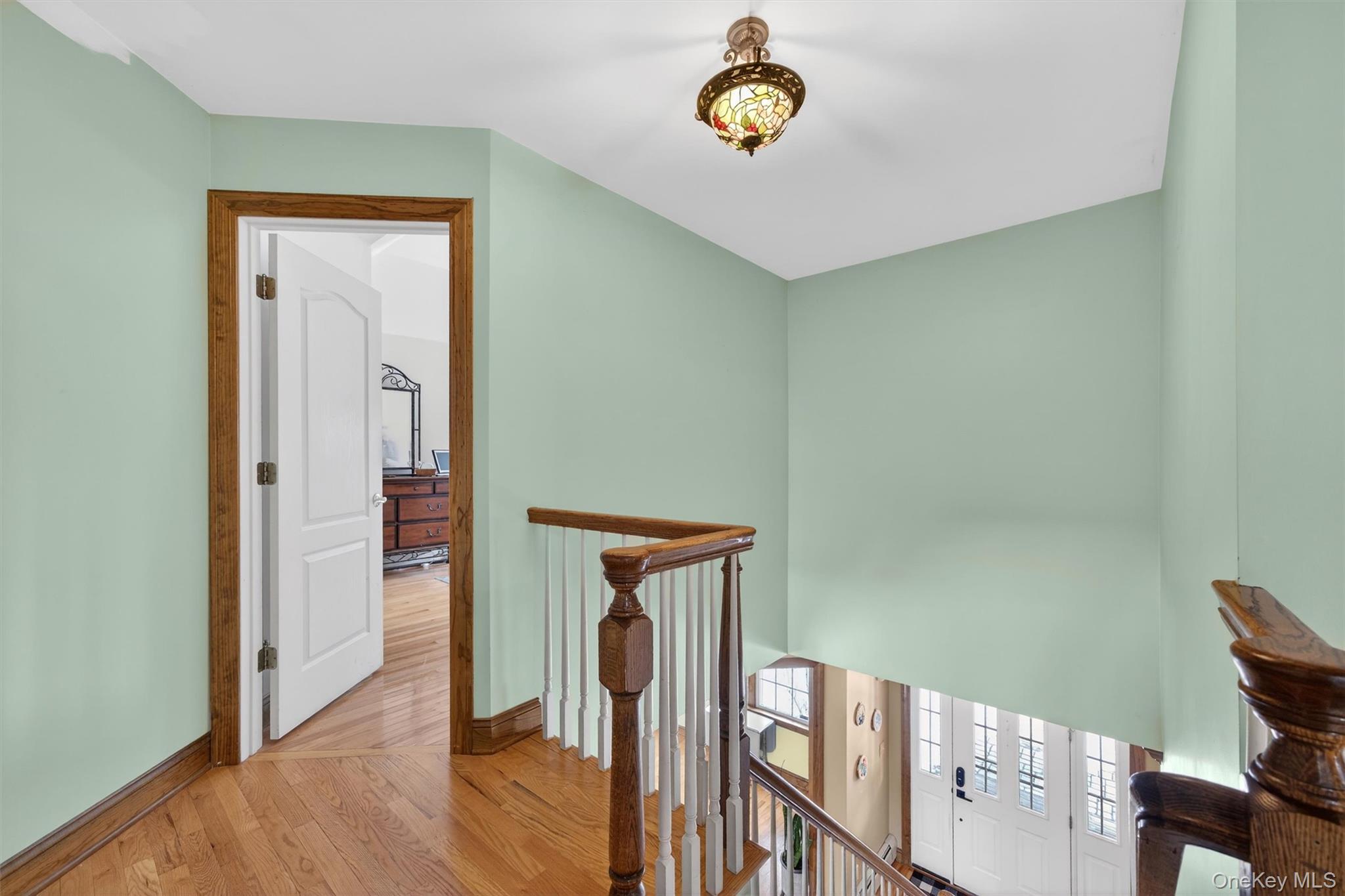 72 Coppergate Lane Warwick, NY 10990 - Photo 35 of 50 a view of a hallway with wooden floor and chair