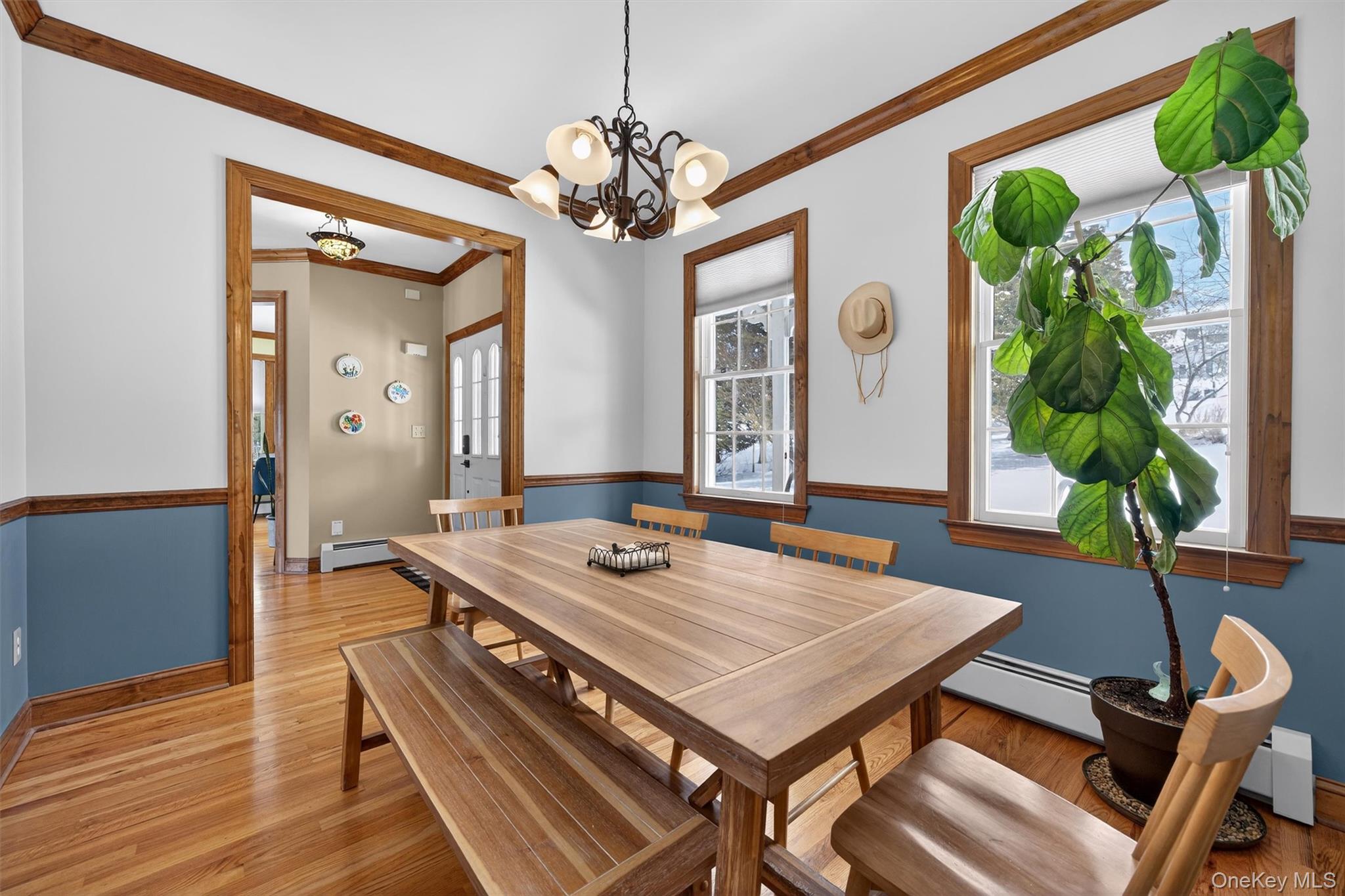 72 Coppergate Lane Warwick, NY 10990 - Photo 4 of 50 a dining room with wooden floor a chandelier a wooden table and chairs
