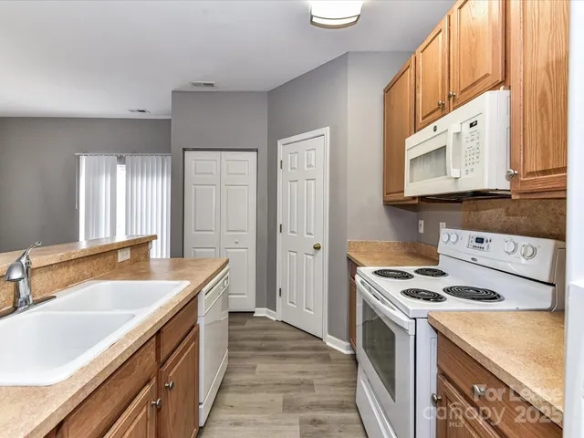 a kitchen with stainless steel appliances granite countertop a sink and a stove