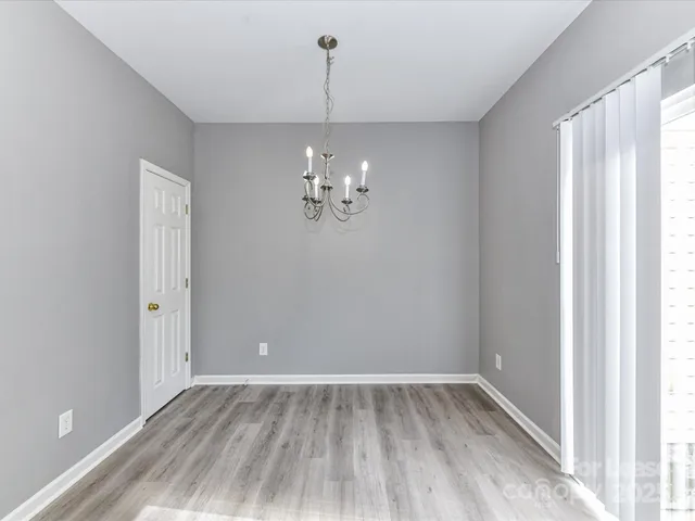 a view of a room with wooden floor and window