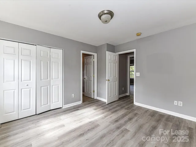 an empty room with wooden floor and closet